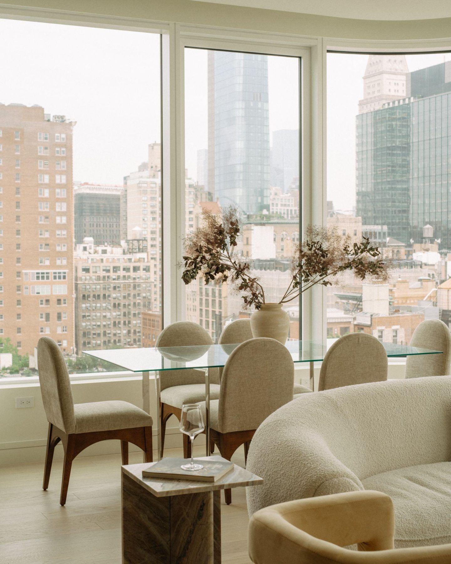 Living and dining room with city views at 200 East 20th Street, staged by Stage One
